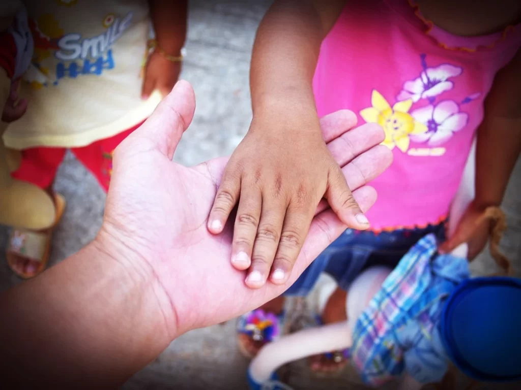 Child's Hand and Older Person's Hand