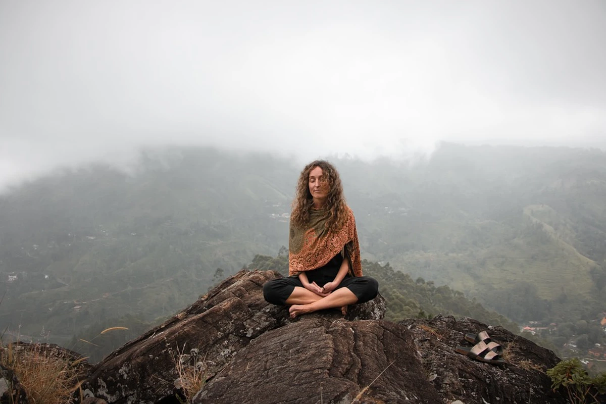 Woman Meditating on a Rock Outside